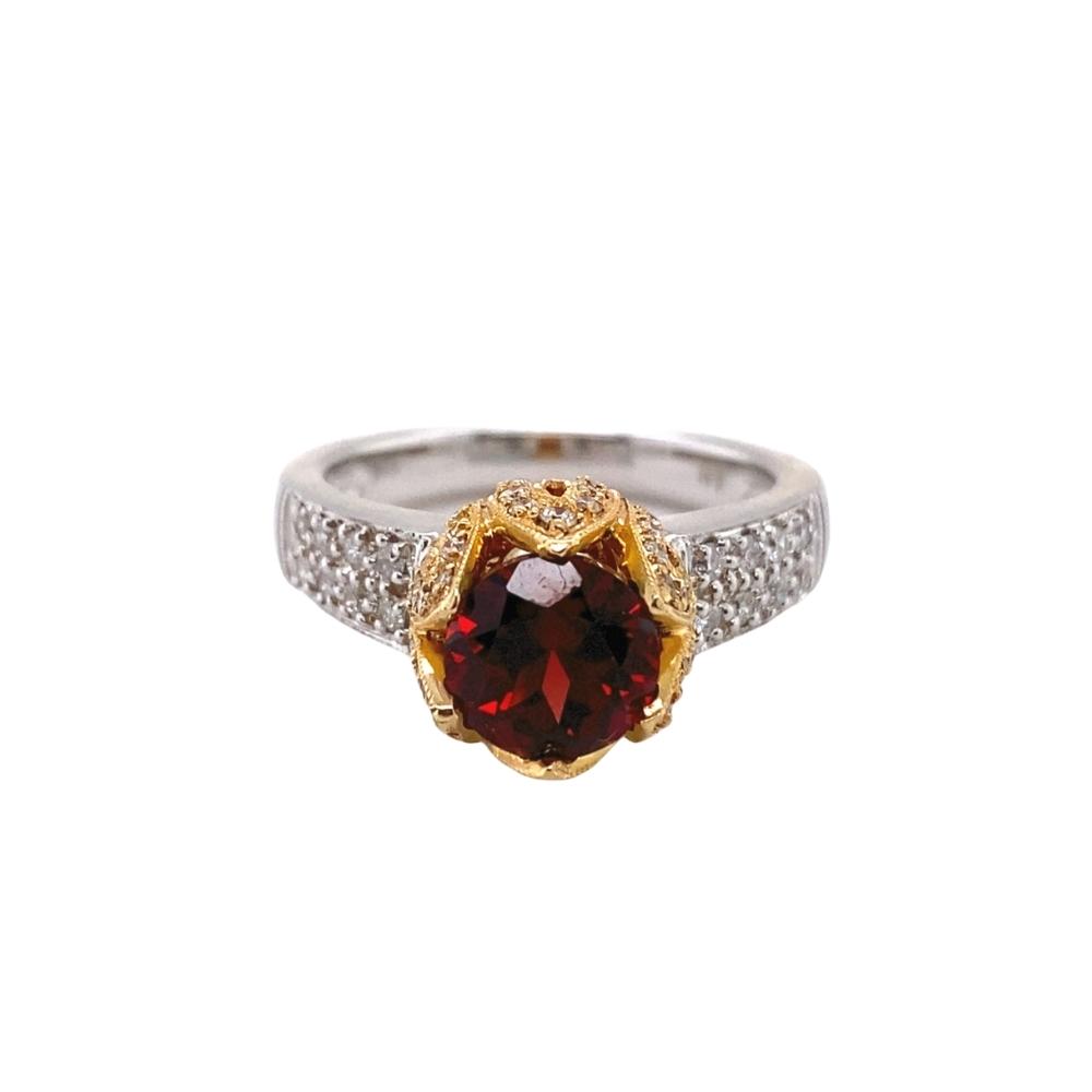 a ring with a large red stone surrounded by white diamonds