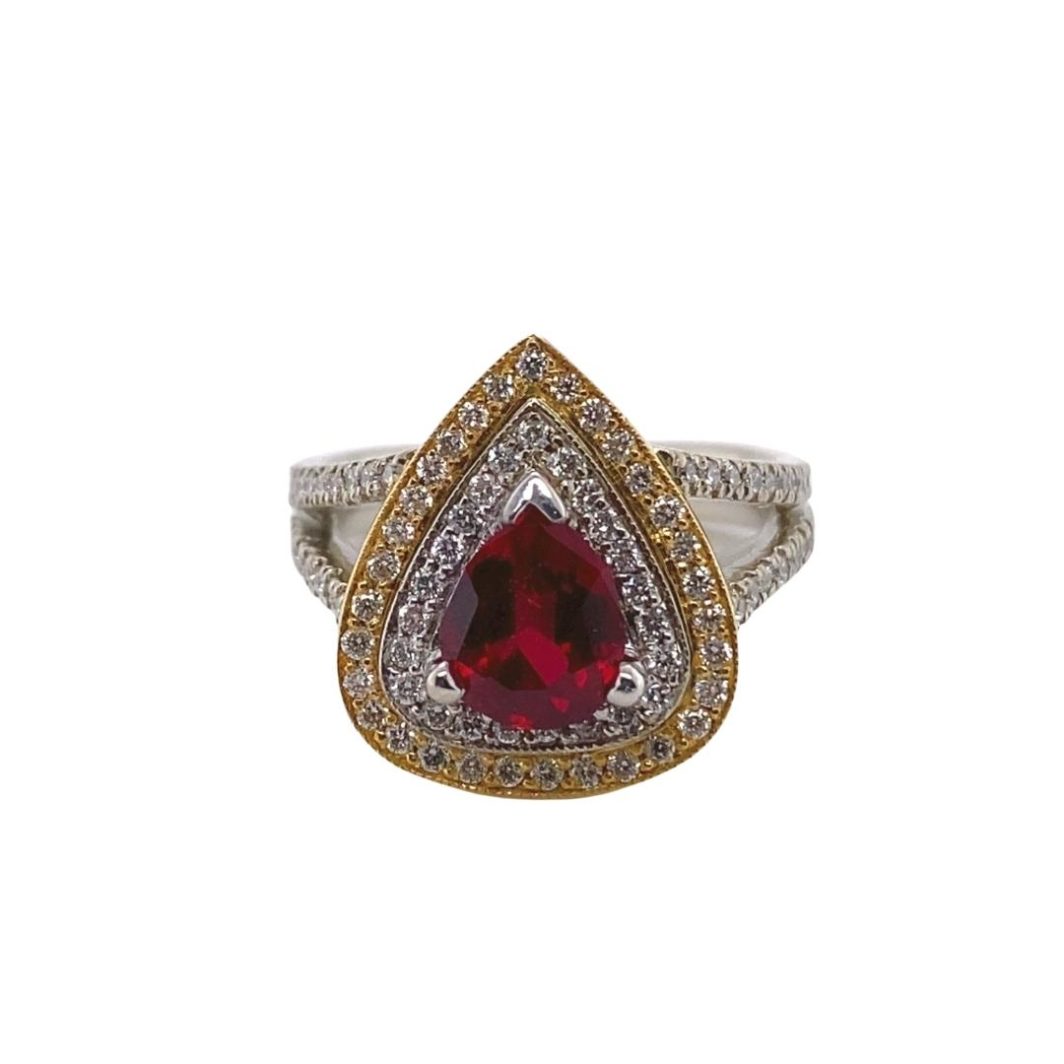 a ring with a large red stone surrounded by white and yellow diamonds