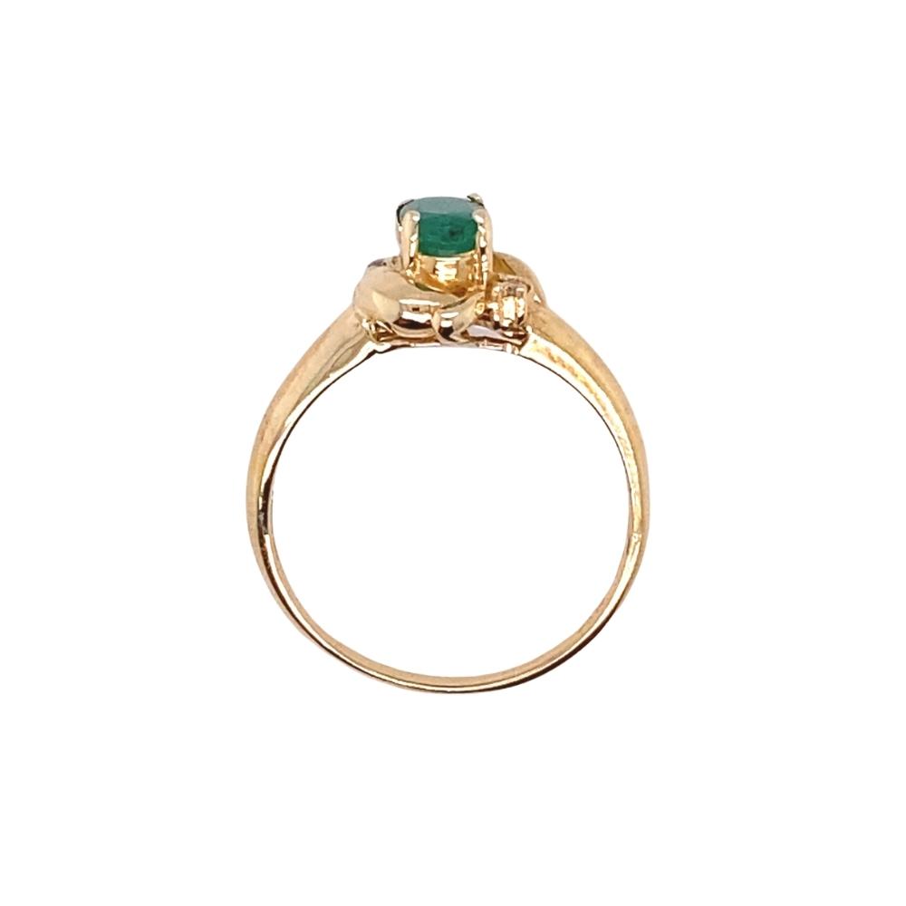 a gold ring with an emerald stone