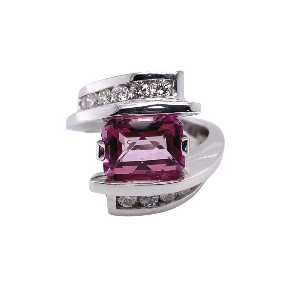 a ring with a pink stone and diamonds on it