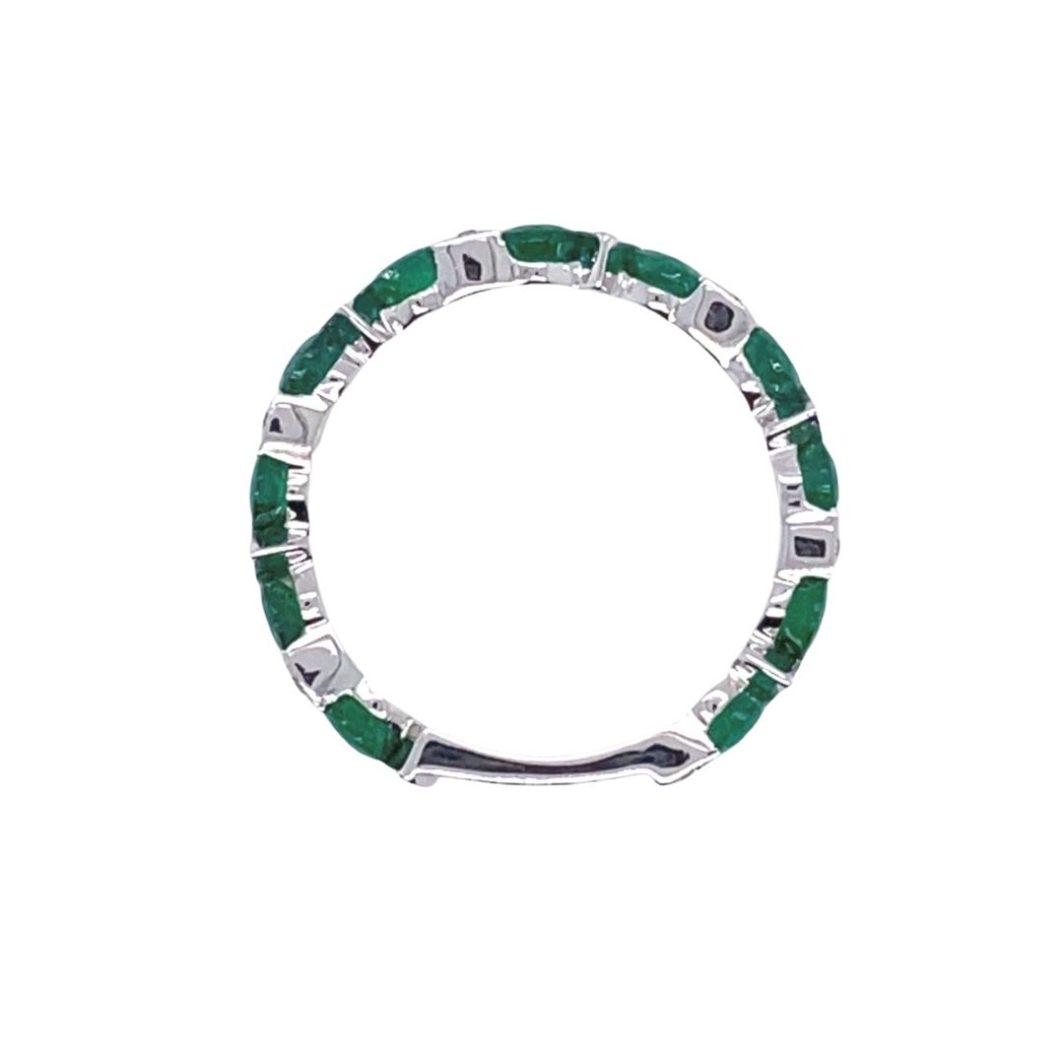 a ring with green stones in the middle