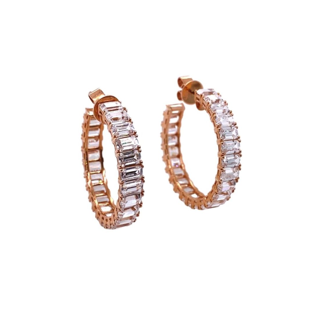 a pair of gold hoop earrings with white stones
