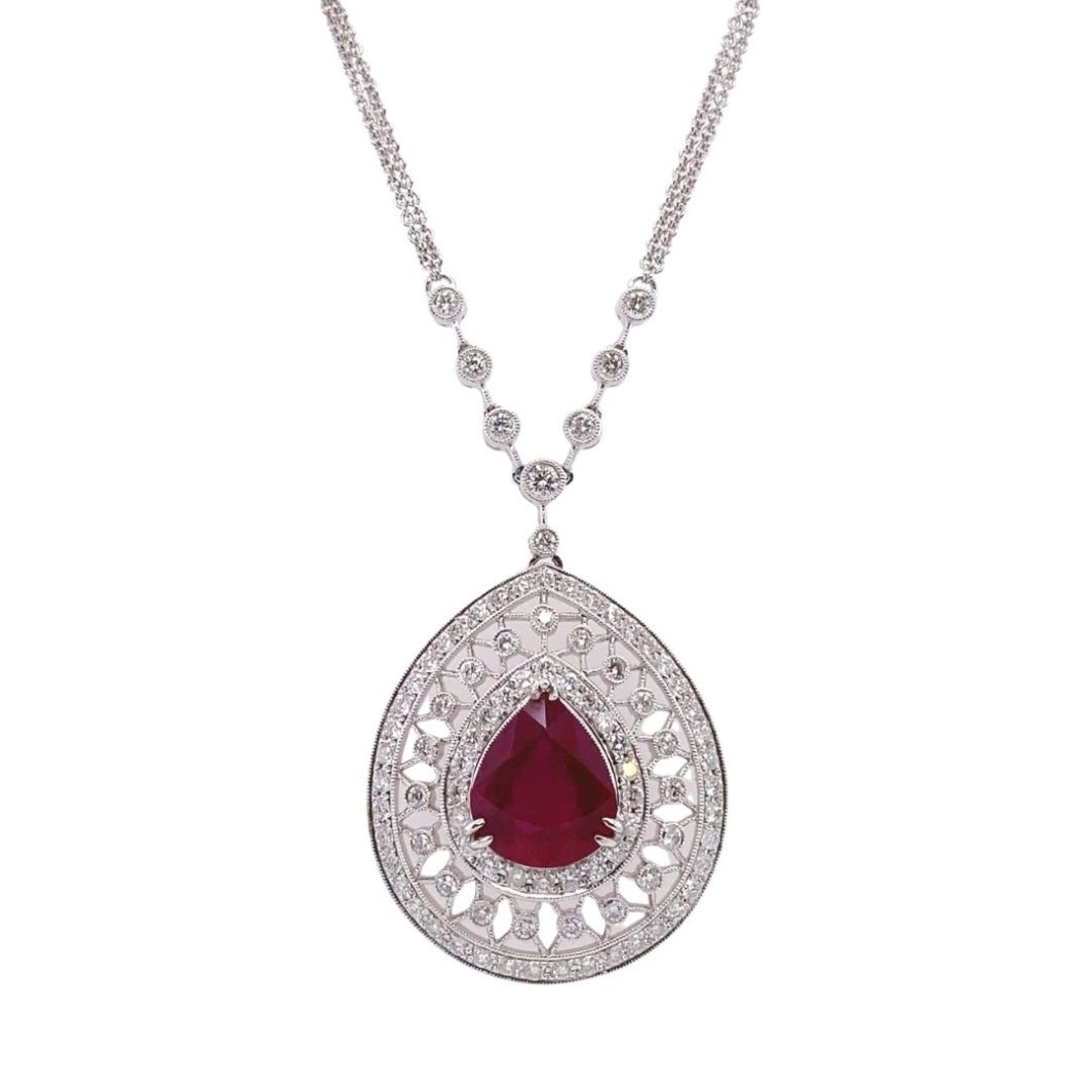 a necklace with a red tear shaped stone