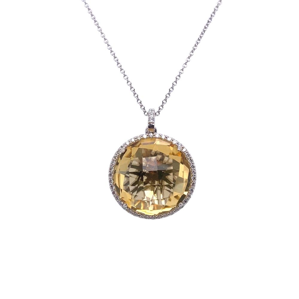 a necklace with an oval shaped yellow topazte surrounded by diamonds