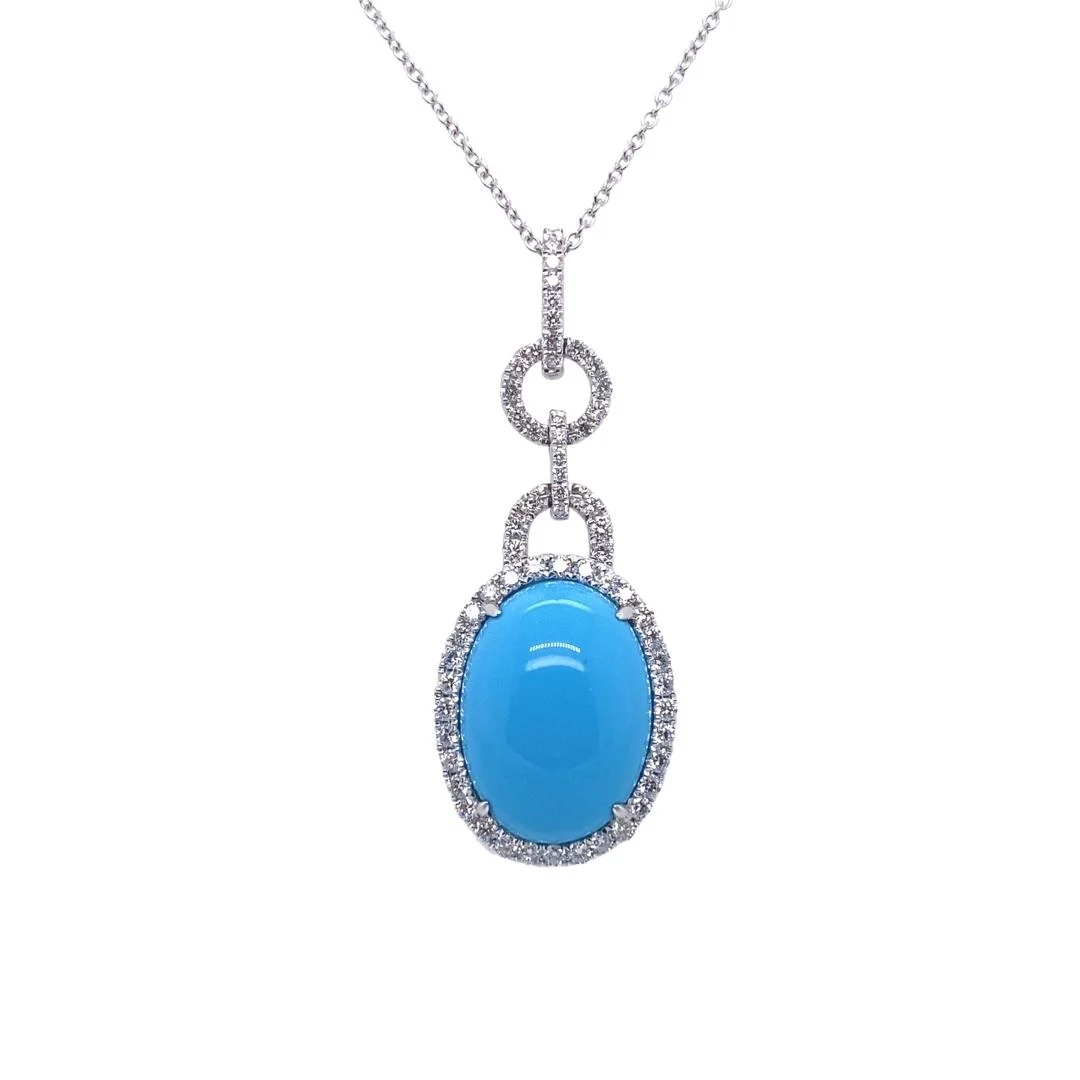 a blue stone and diamond pendant on a chain