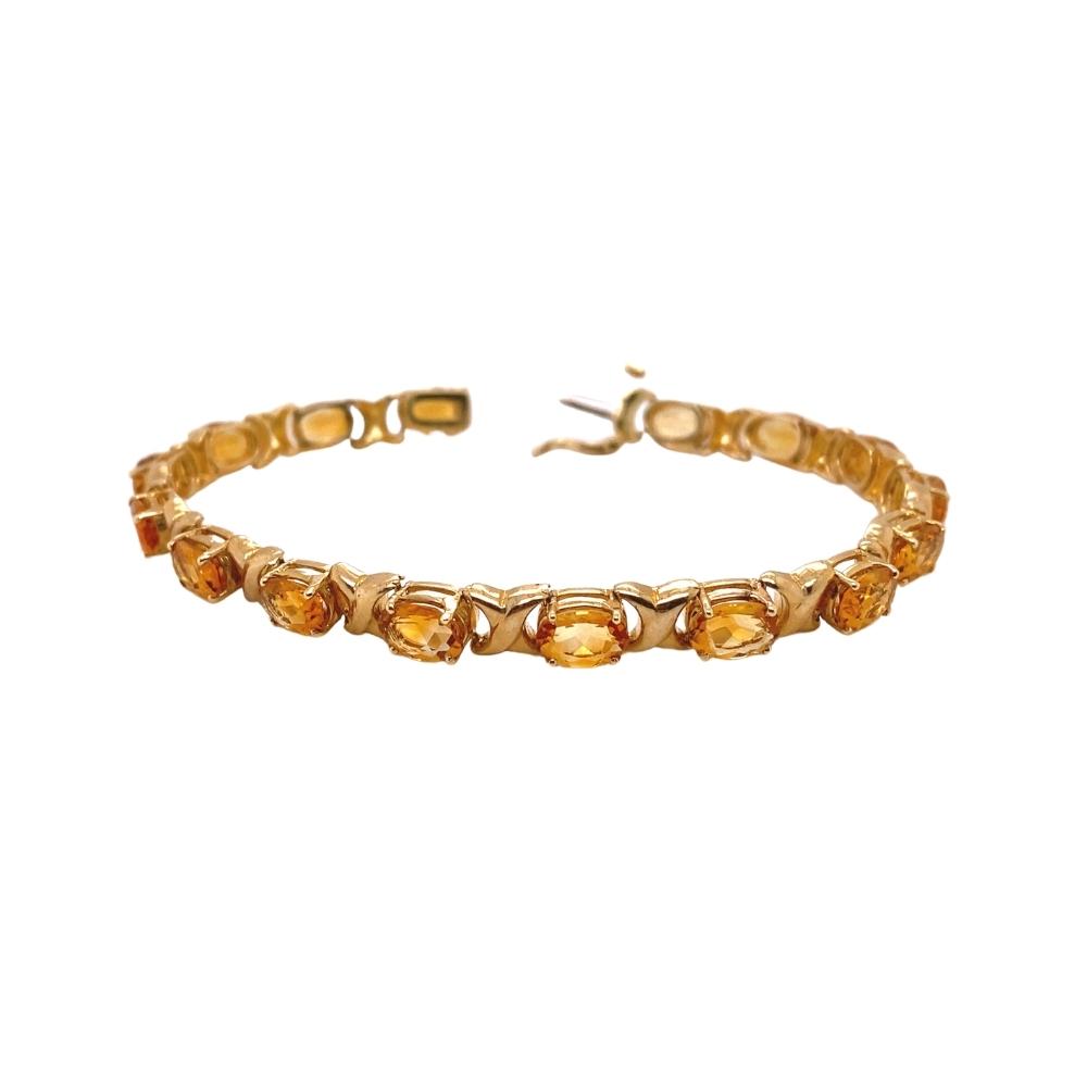 a gold bracelet with citrine beads