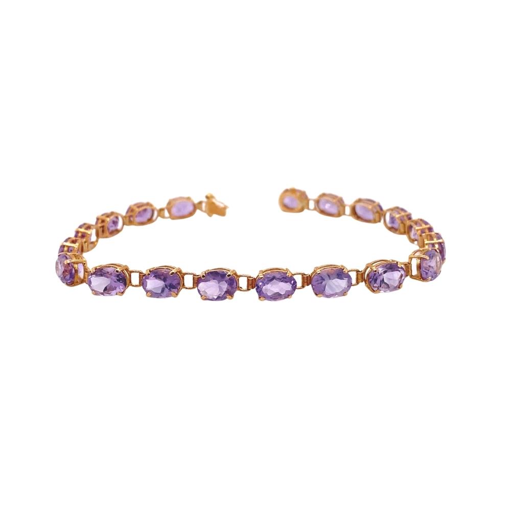 a gold bracelet with purple stones