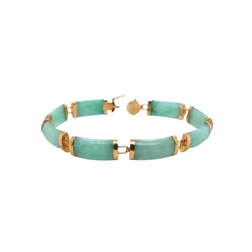 a green bracelet with gold accents