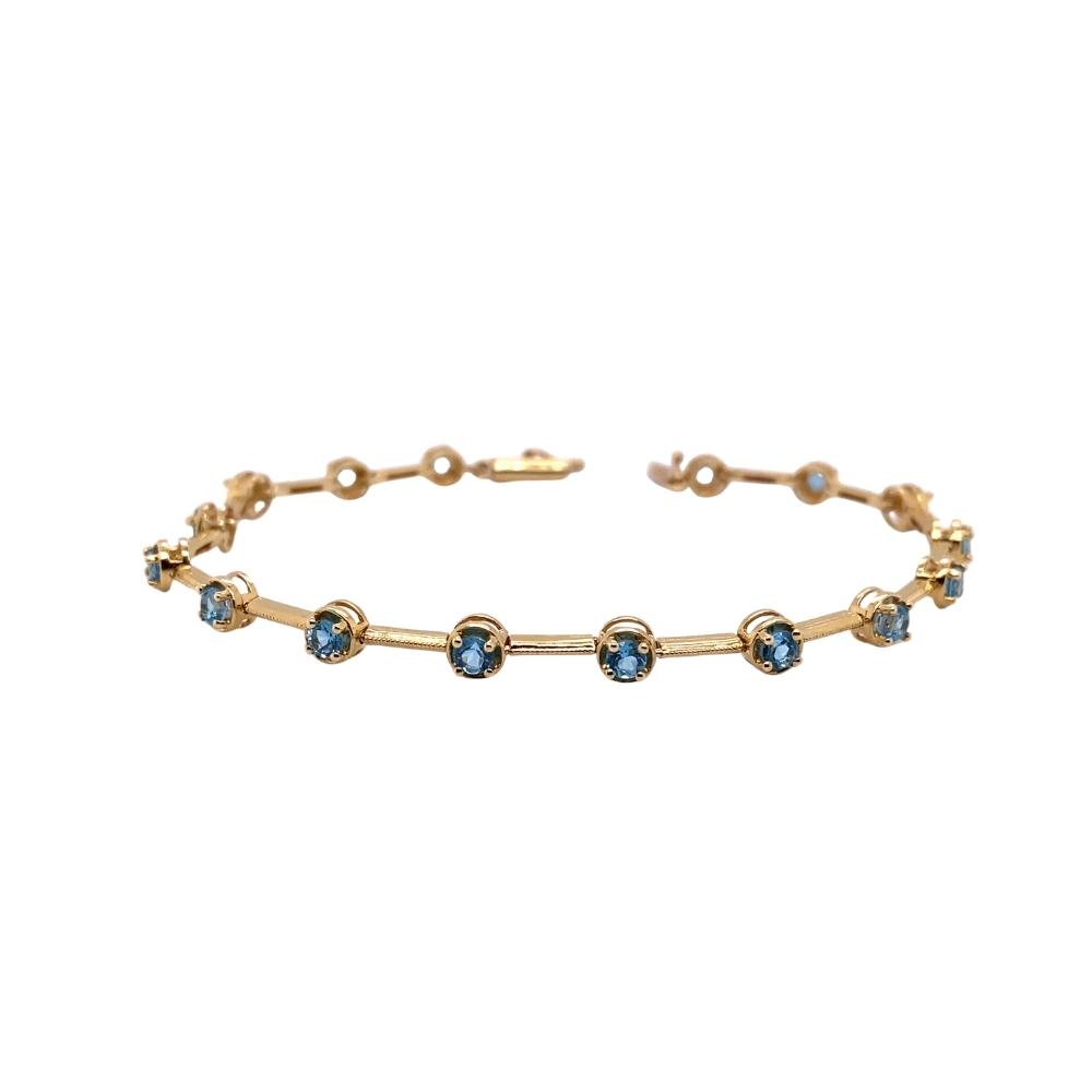 a gold bracelet with blue stones