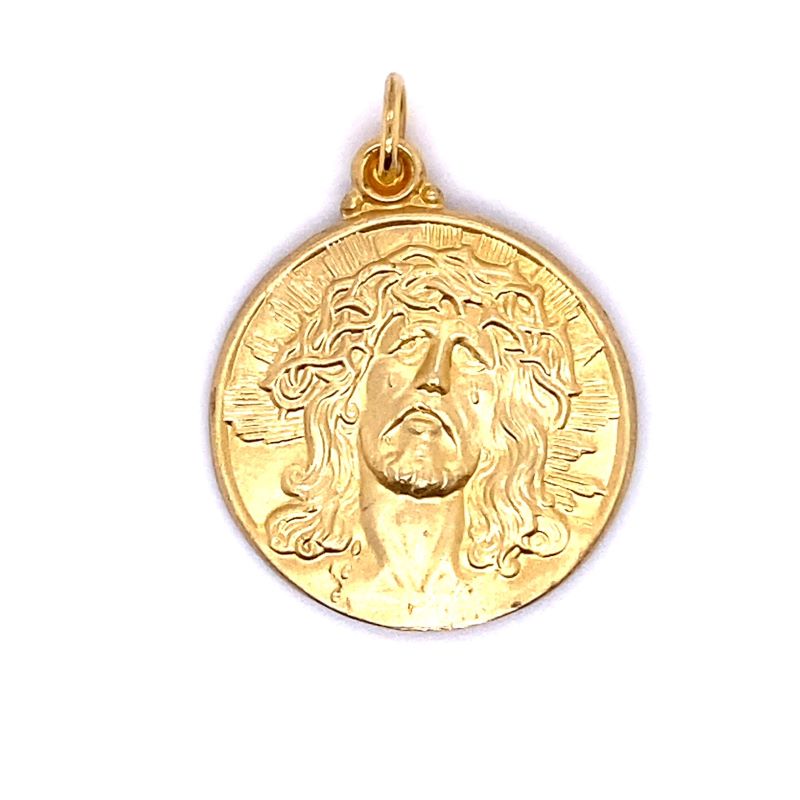 the face of jesus in gold on a white background