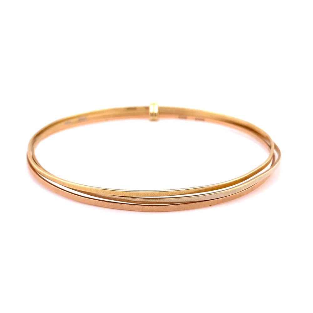two thin gold bang bracelets on a white background