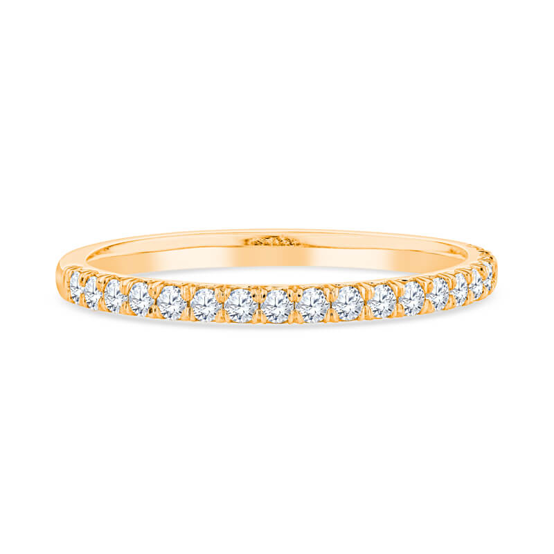 a yellow gold wedding band with diamonds