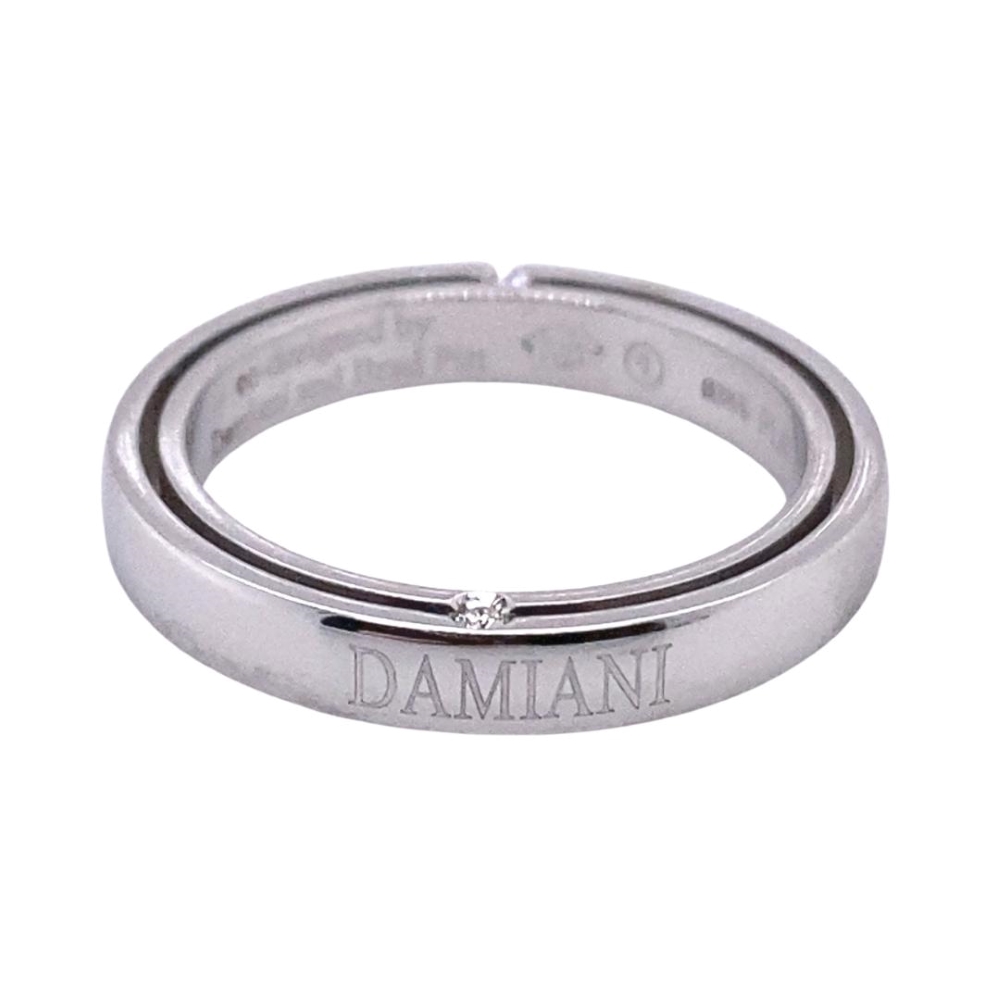 a white gold ring with the word damn on it