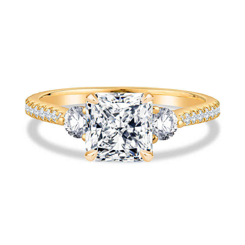 a yellow gold engagement ring with a princess cut diamond