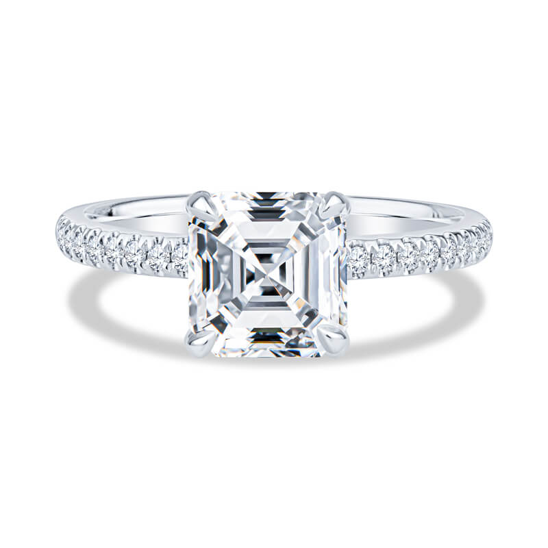 an emerald cut diamond ring with pave set shoulders