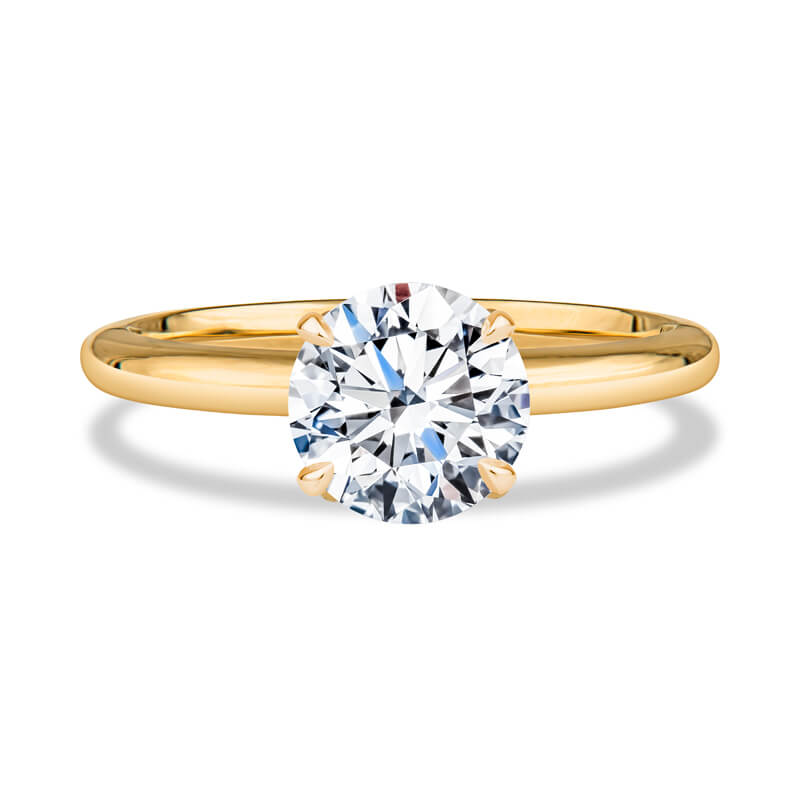 a yellow gold engagement ring with a round diamond