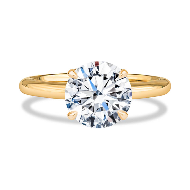 a yellow gold engagement ring with a round diamond