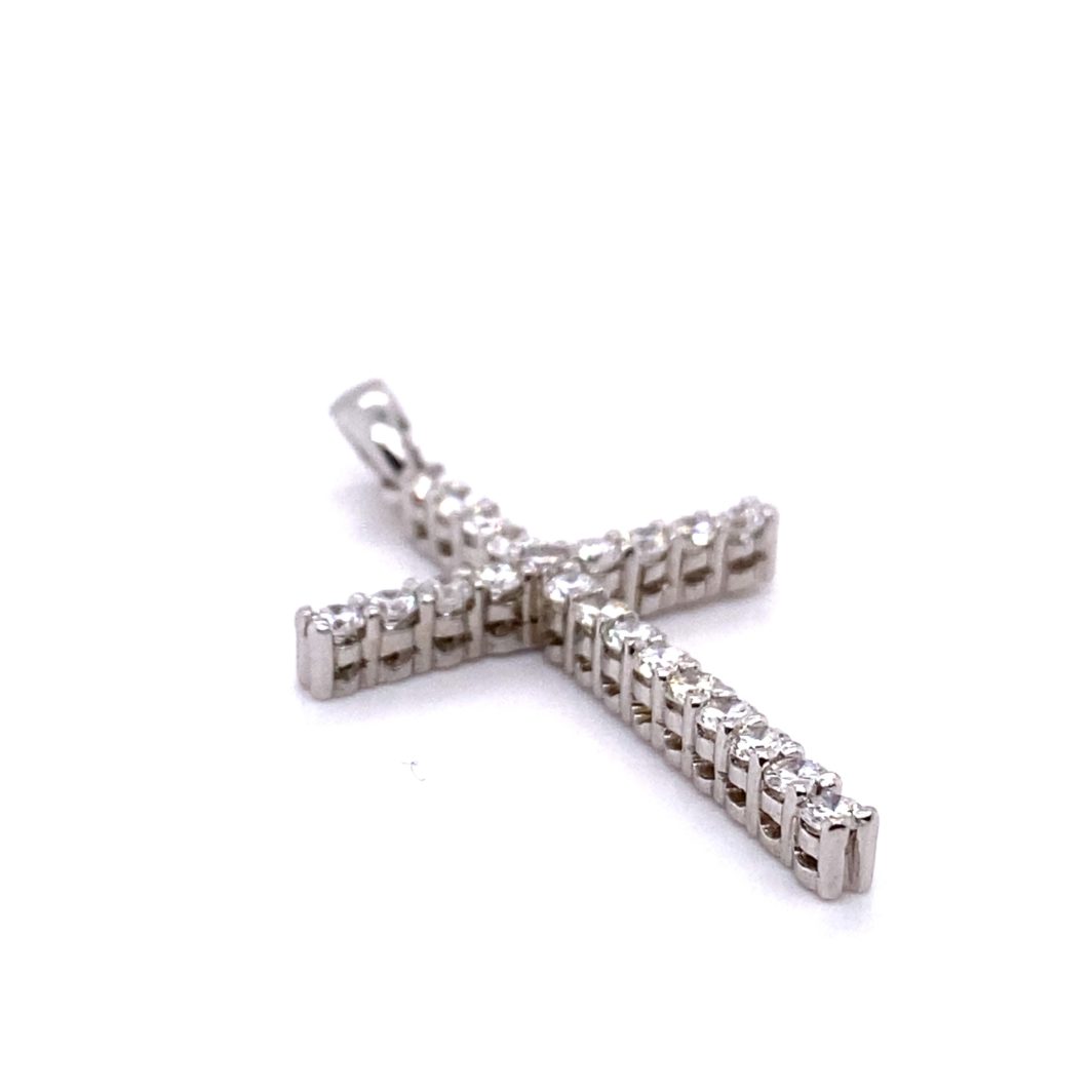 a silver cross pendant on a white background