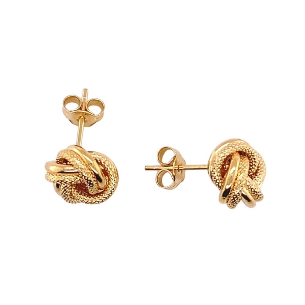 a pair of gold toned earrings