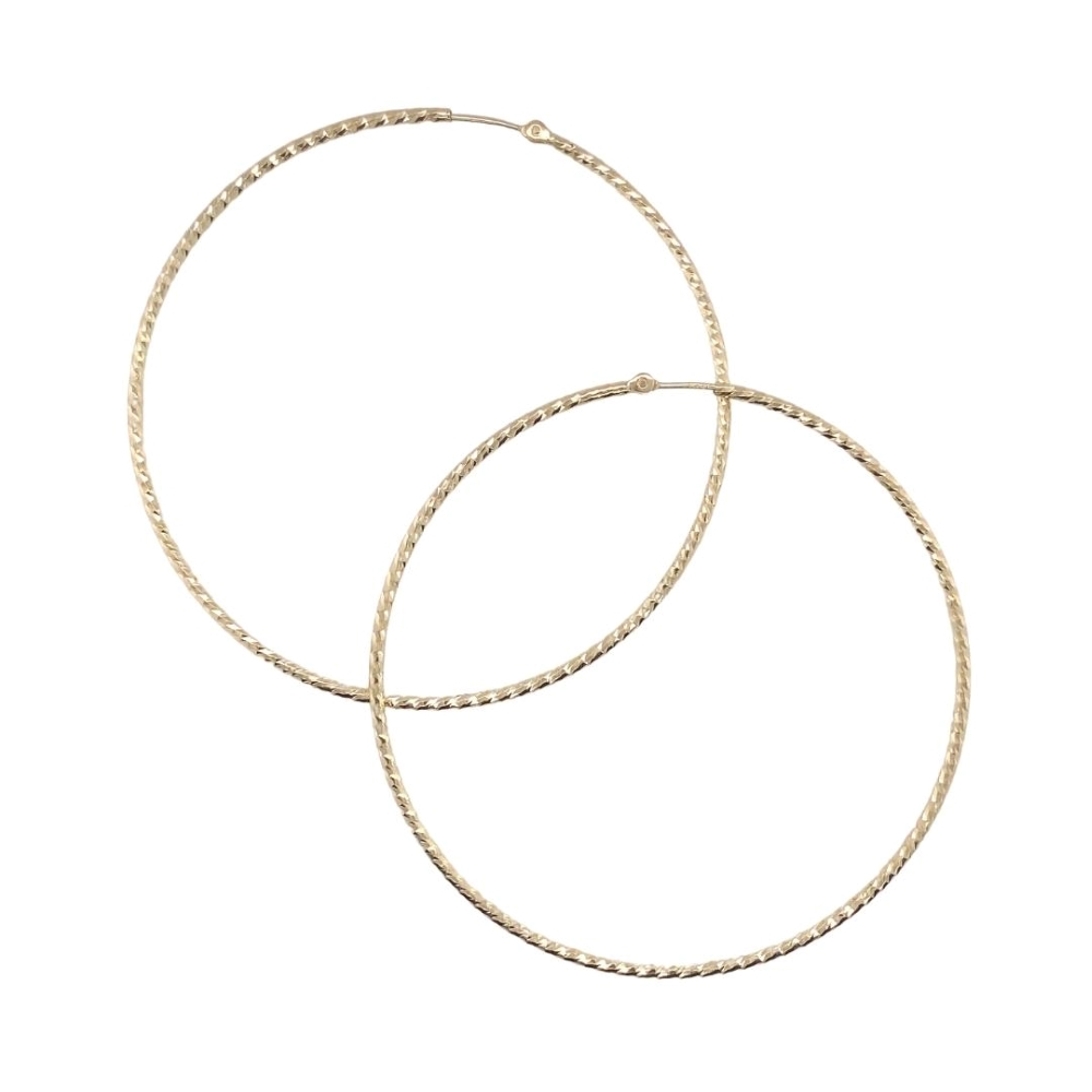 two large gold hoop earrings on a white background