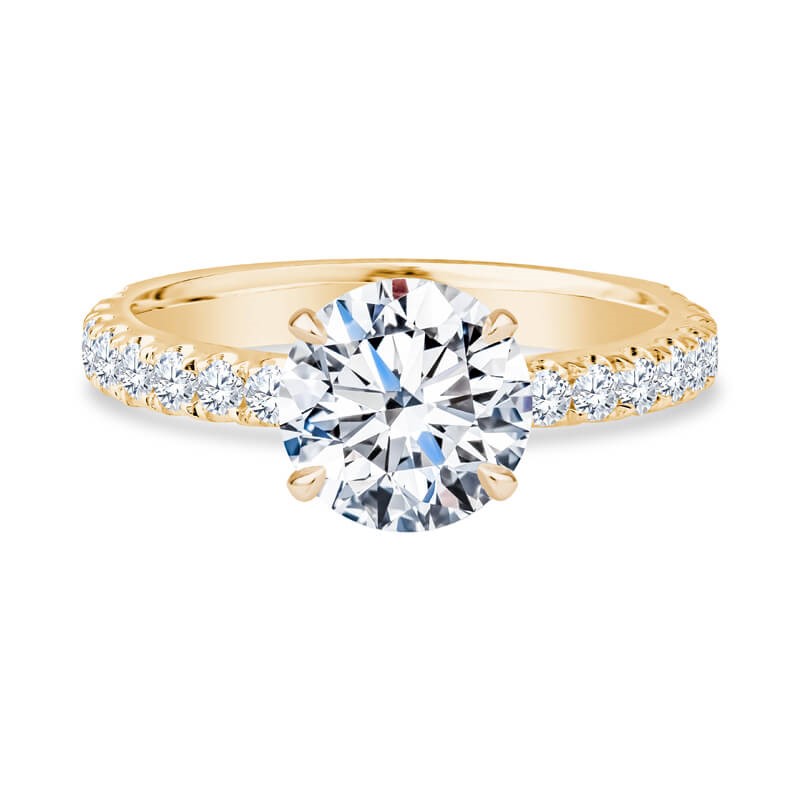 a yellow gold engagement ring with diamonds on the side