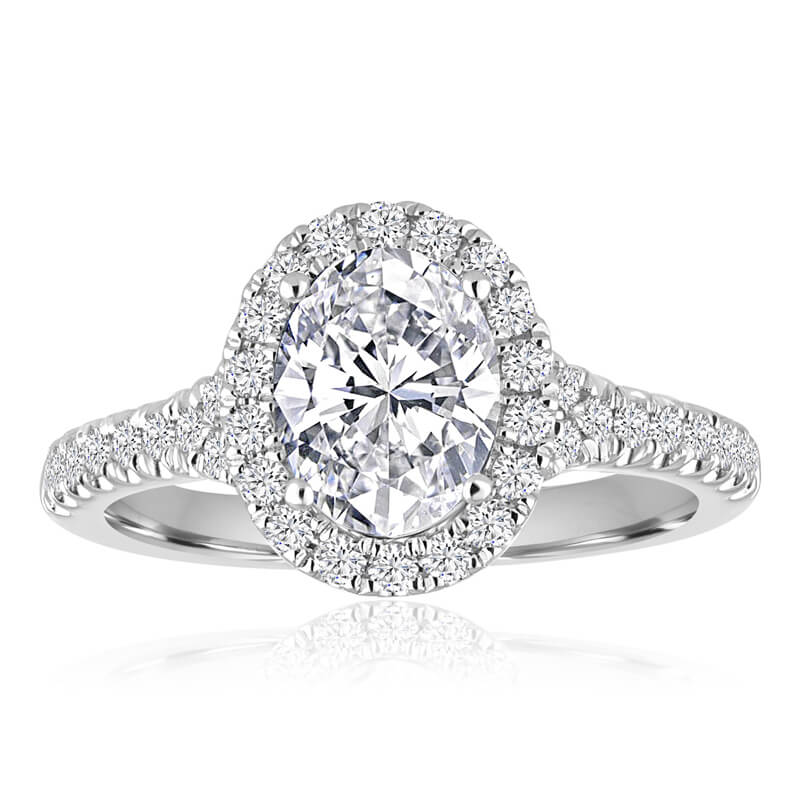 a diamond engagement ring with an oval center surrounded by round diamonds