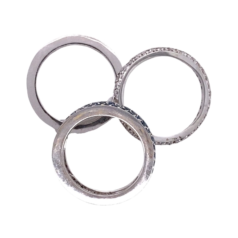 three silver rings with diamonds on them