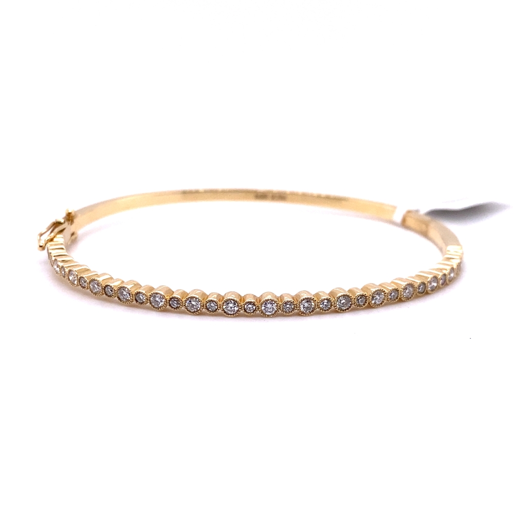a close up of a gold bracelet on a white background