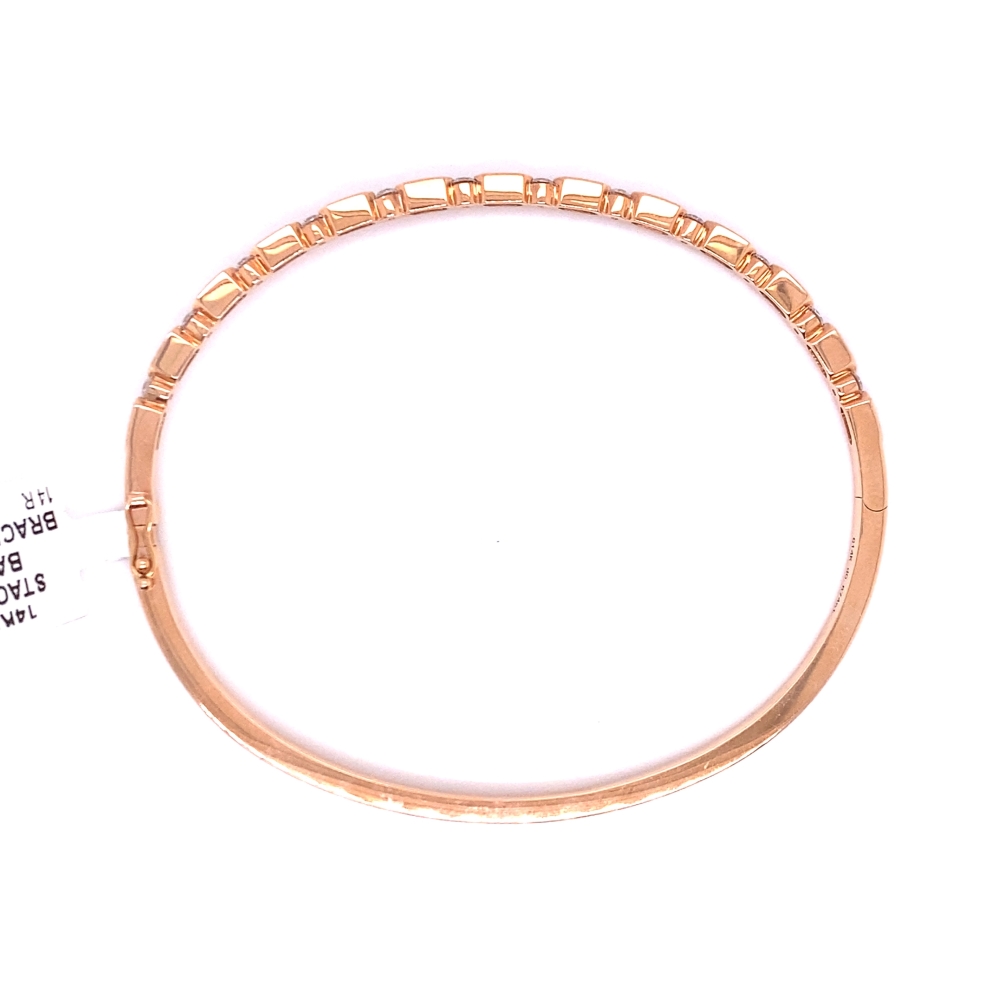 a close up of a gold bracelet on a white background