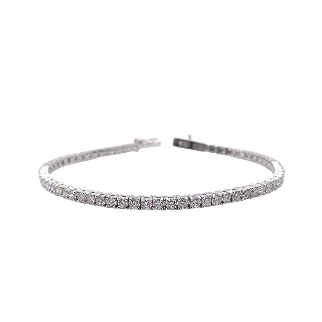 a diamond tennis bracelet on a white background