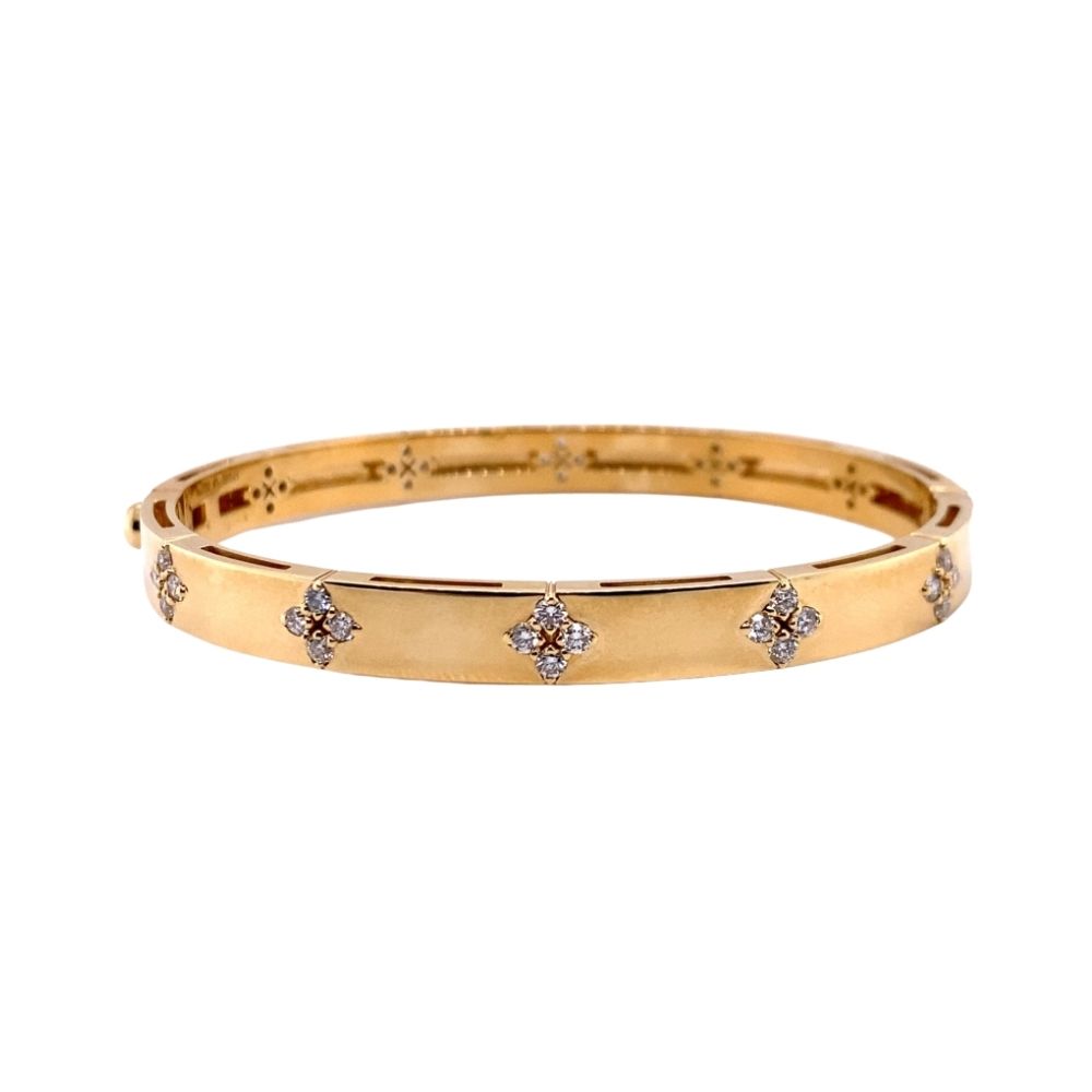a gold bang bracelet with diamonds on it