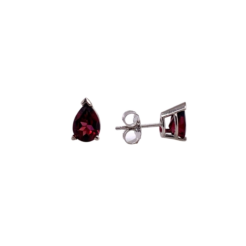 a pair of earrings with a red stone