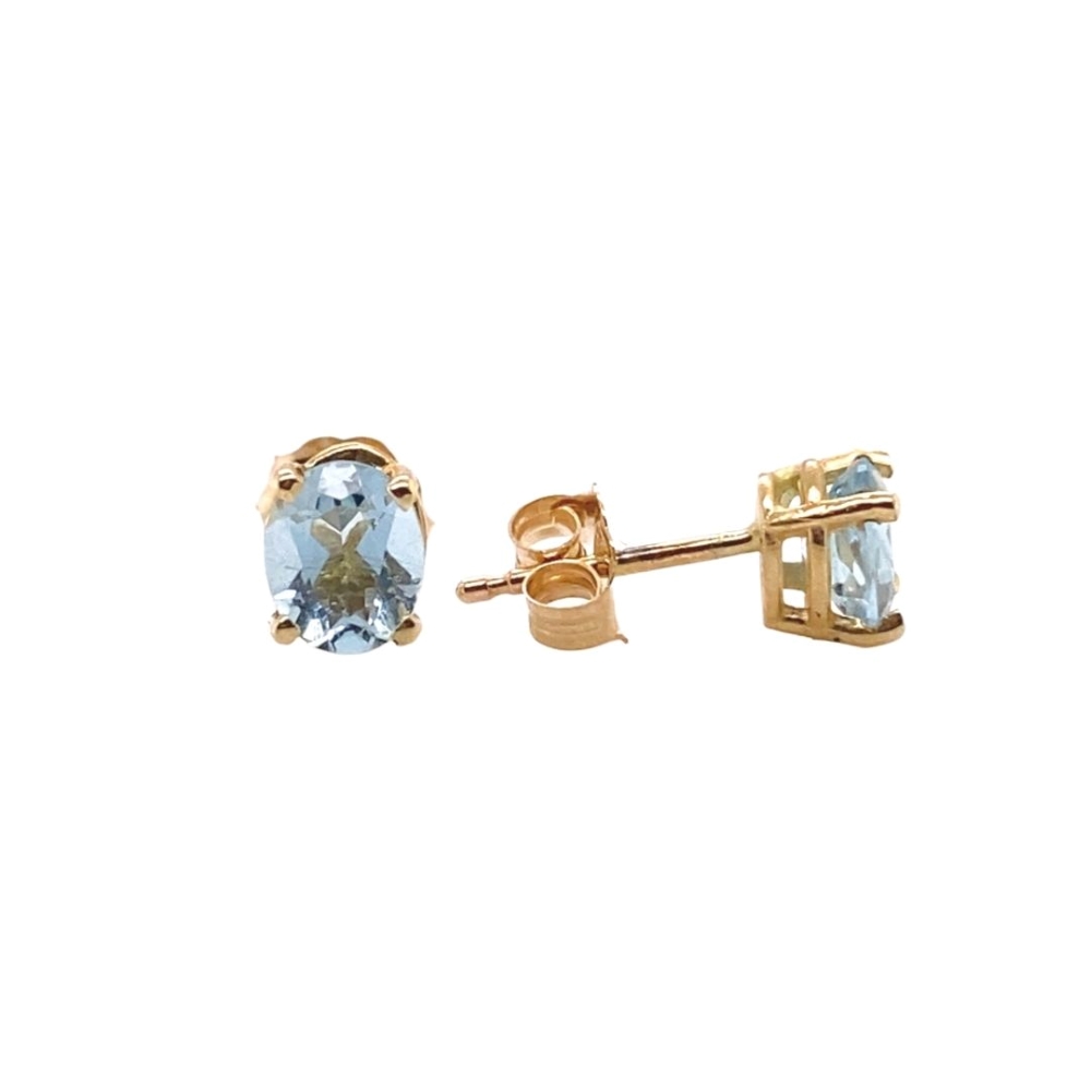 a pair of gold earrings with blue topaz