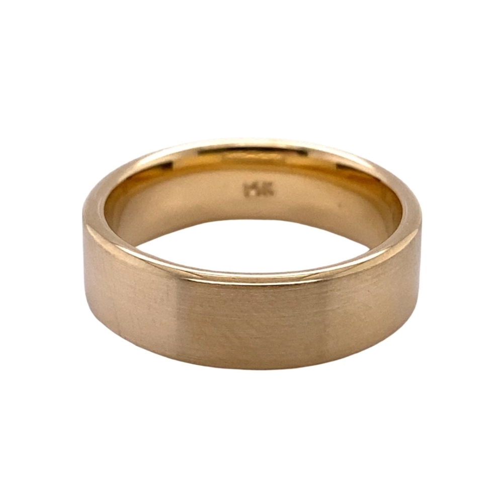 a gold wedding ring on a white background