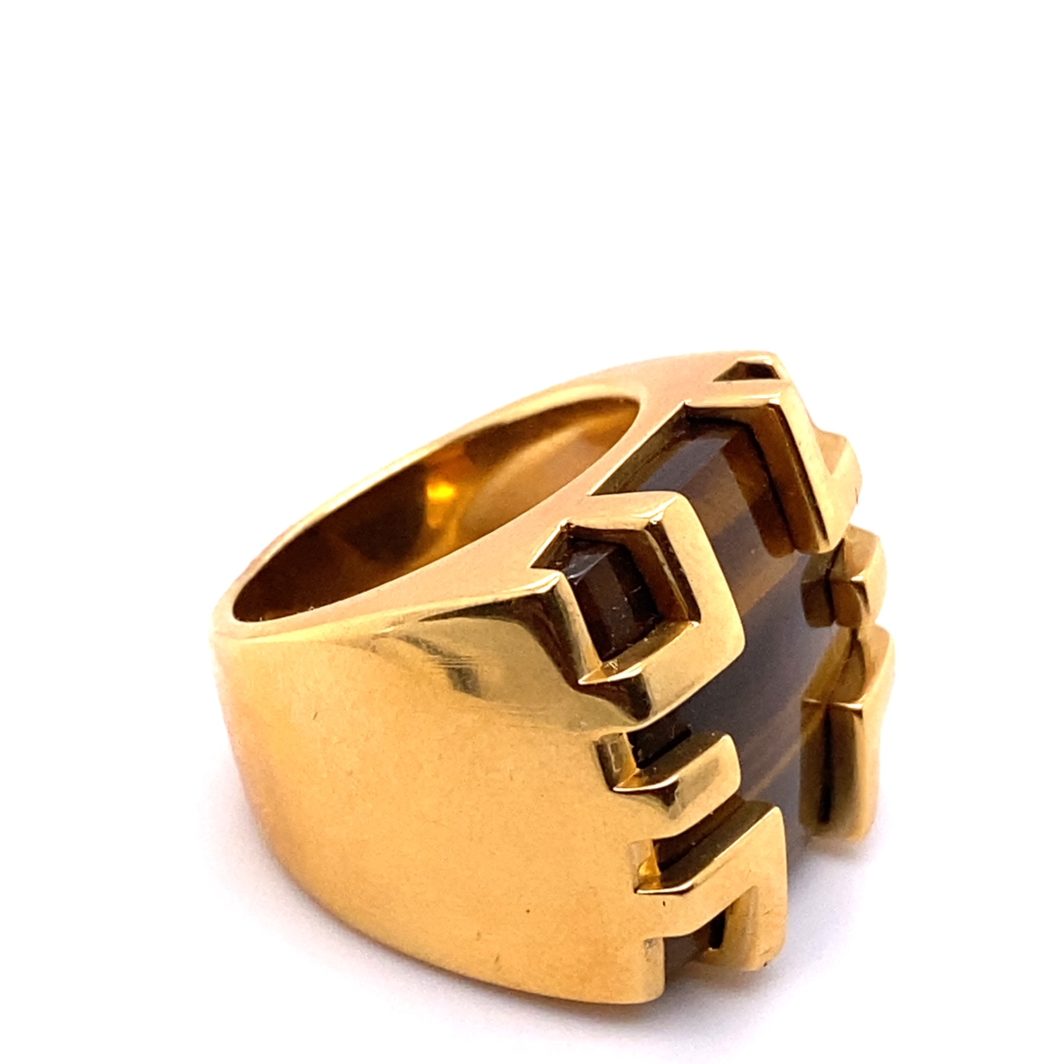 a gold ring with brown stones on it