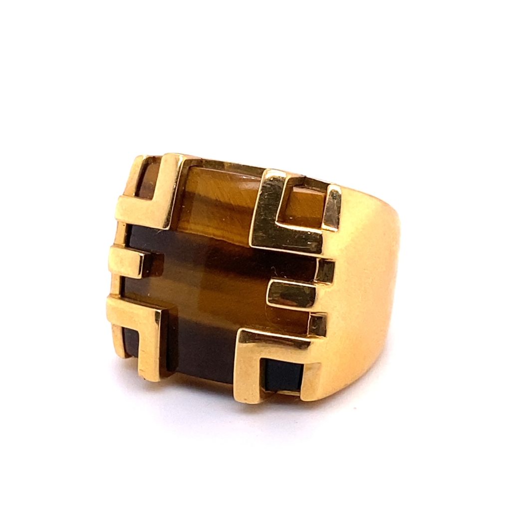 a gold ring with tiger's eye stone