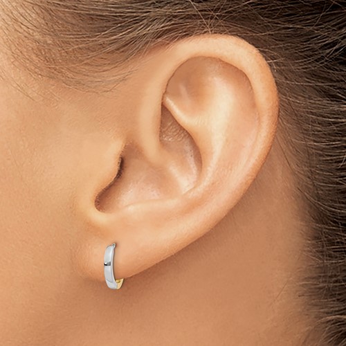 a woman's ear with a small silver hoop