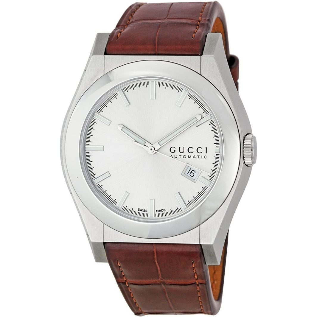 a silver watch with brown leather strap
