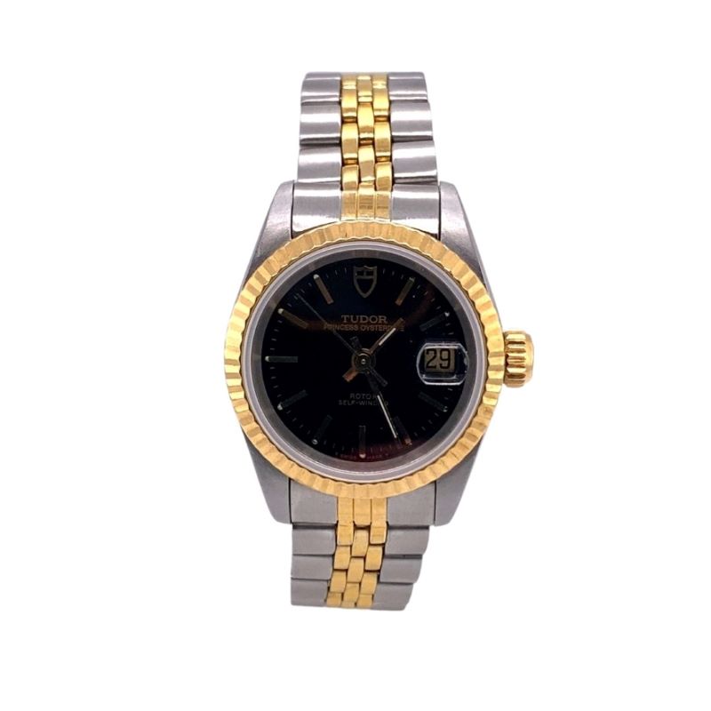 a watch with two tone gold and black dials