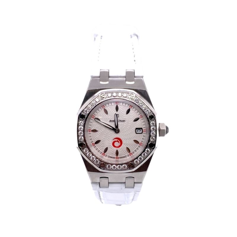 a watch with white dial and red numbers