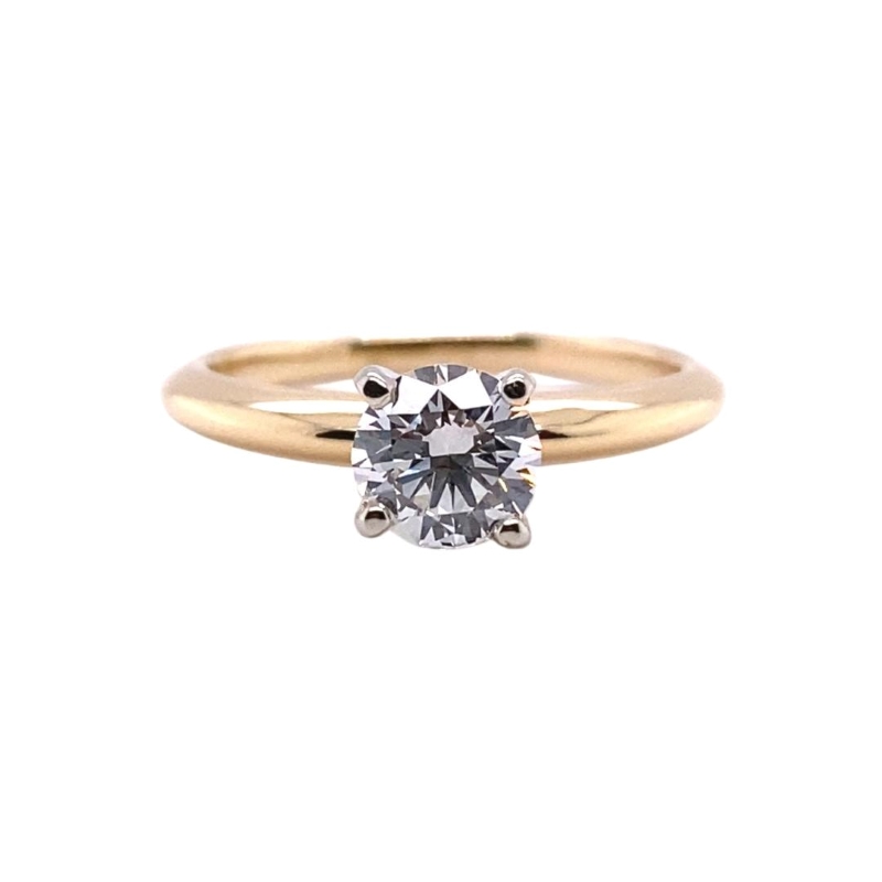 a yellow gold ring with a single diamond