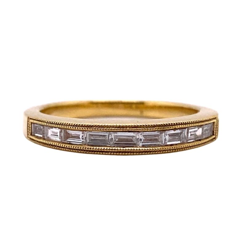 a gold ring with baguets and diamonds