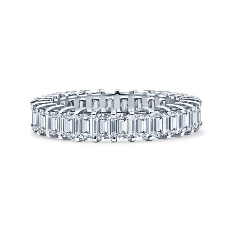 an emerald cut diamond ring on a white background