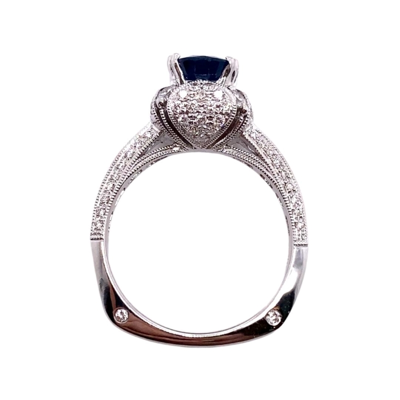 a white gold ring with a blue stone in the center
