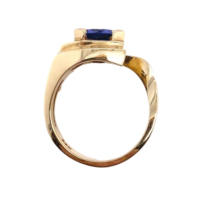 a yellow gold ring with a blue stone