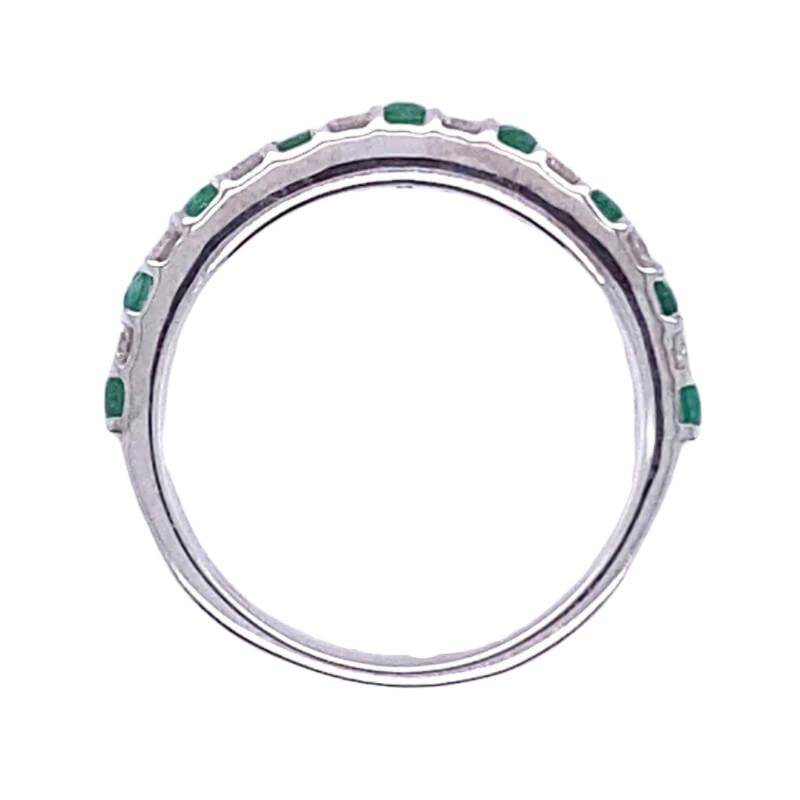 a white gold ring with emerald stones