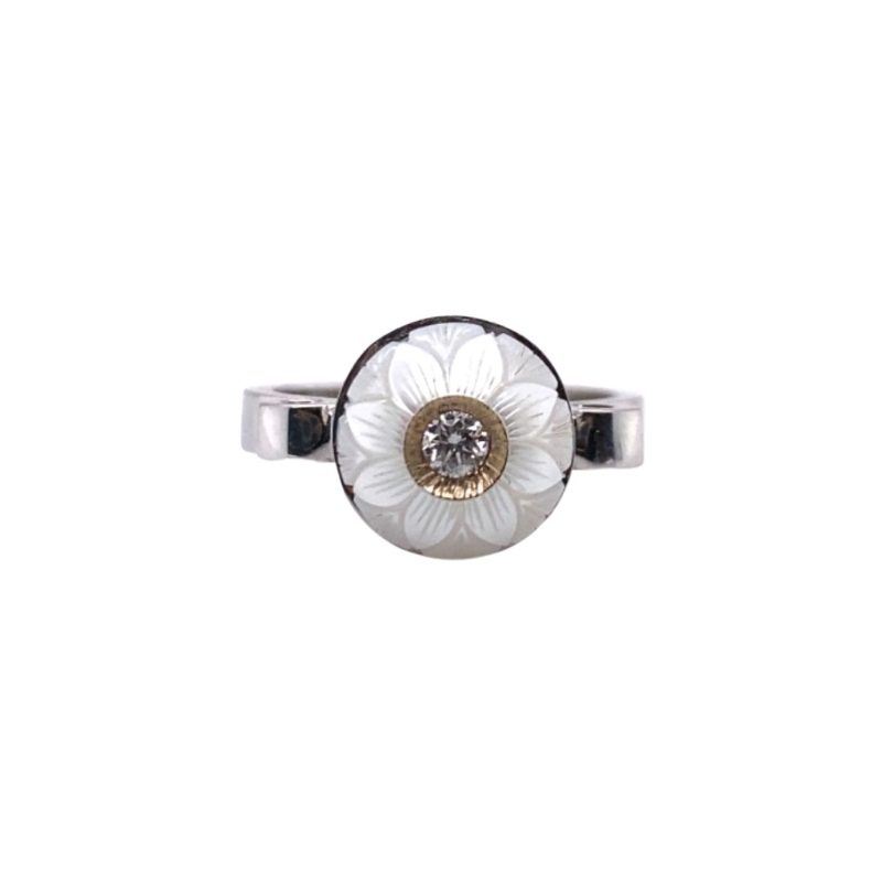 a ring with a white flower on it