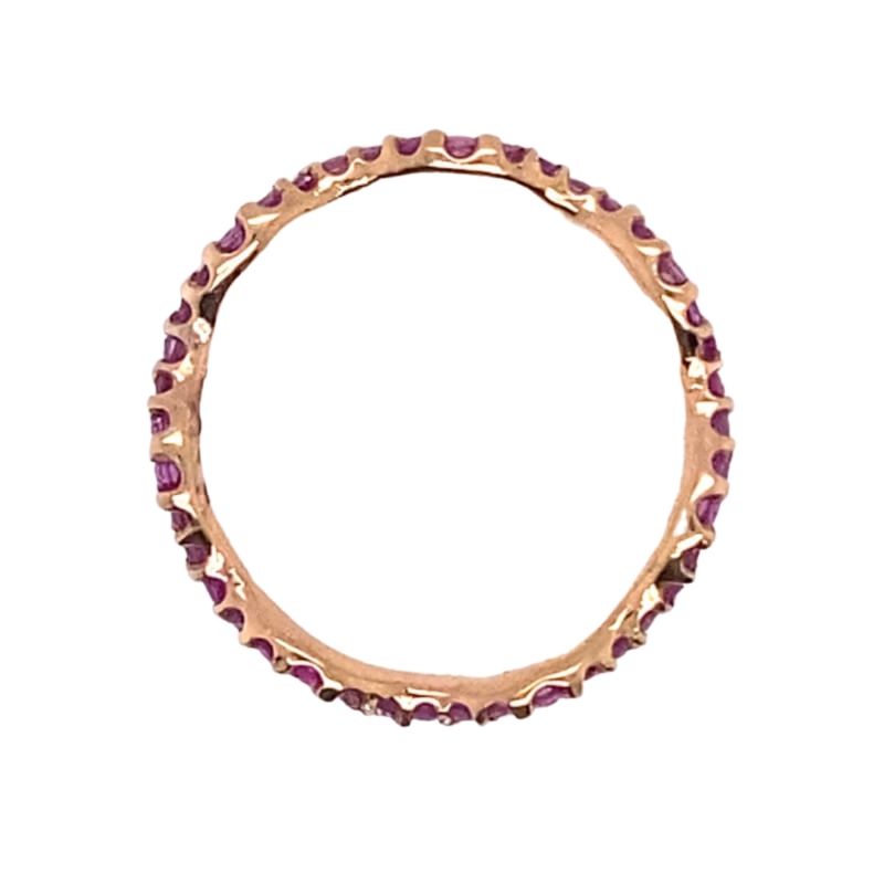 a gold ring with pink stones on it
