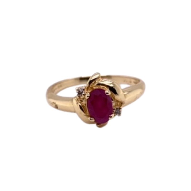 a gold ring with a red stone and two diamonds