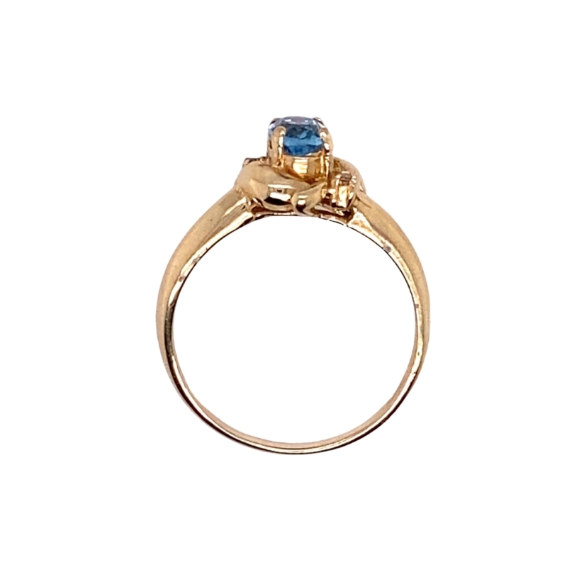a gold ring with a blue stone on top